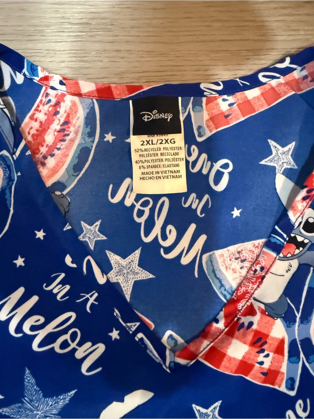 Disney royal blue scrub top with red and white watermelon motif - Picture 2 of 3